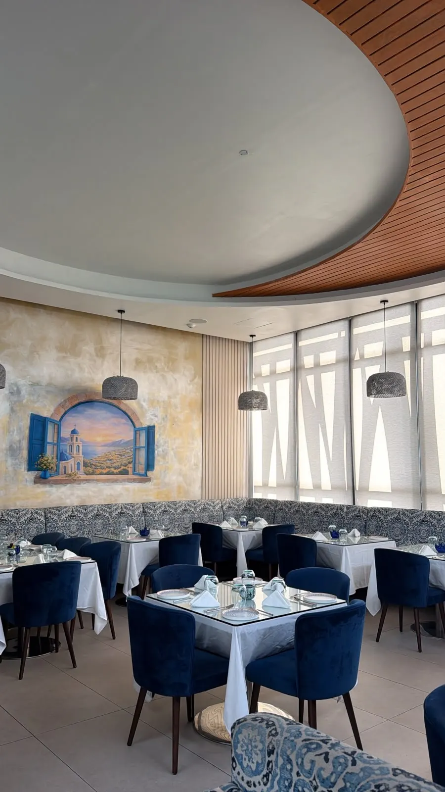 Mezza Luna terrace dining area and bar with woven pendant lights