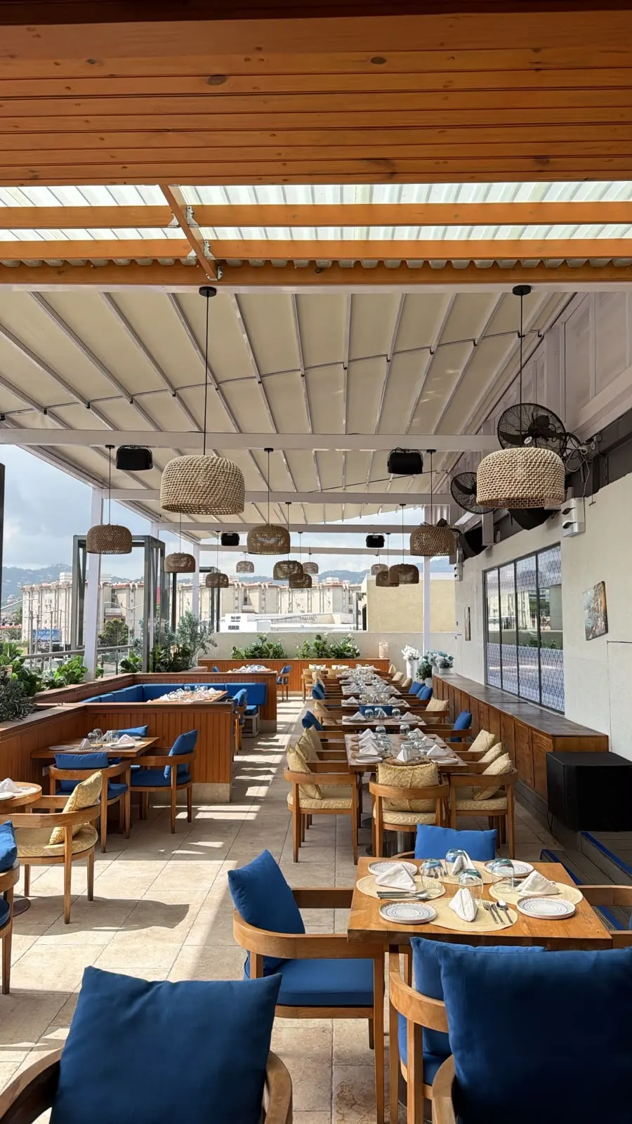 Mezza Luna open-air terrace restaurant with timber seating